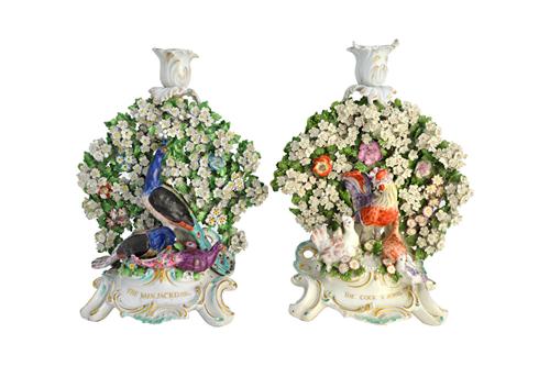 A pair of Chelsea-Derby fable candlestick groups of `The Cock & Jewel' and `The Vain Jackdaw', circa 1770-75, with a cockerel, chickens, peacocks and