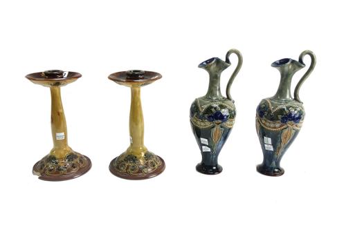 A pair of Royal Doulton stoneware ewers, late 19th/early 20th century, decorated with flowers against a mottled blue and green ground, 29cm high, and