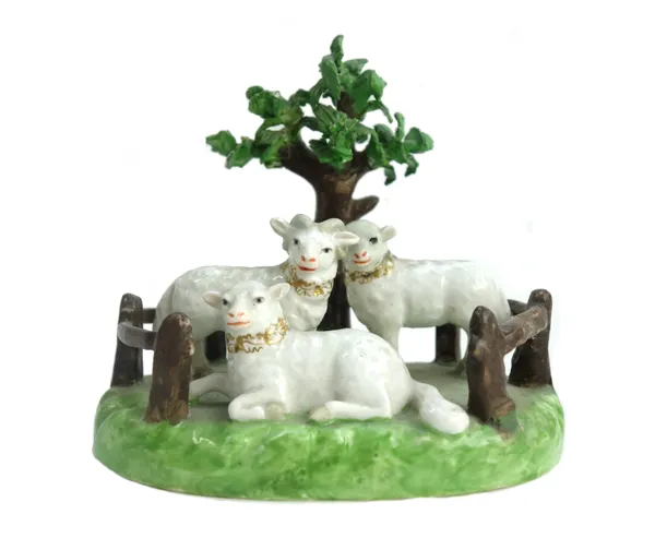 A Derby Stevenson and Hancock porcelain sheep group, early 20th century, the three fenced sheep modelled beneath a tree, 11cm wide. (a.f.)
