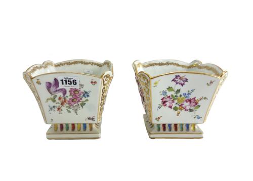 A pair of Capo di Monte cache pot, 20th century, relief decorated with panels of naked classical figures and still life flowers against a tapering squ