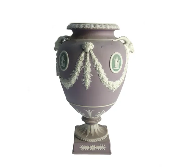 A Wedgwood three-colour jasper vase, late 19th century, of urn form, applied with white goat and ram masks suspending flower swags between green oval