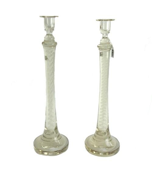 A pair of glass candlesticks, early 20th century, with inclusions to the tapering stem on a wide spreading circular foot (a.f.). 49cm high (2).
