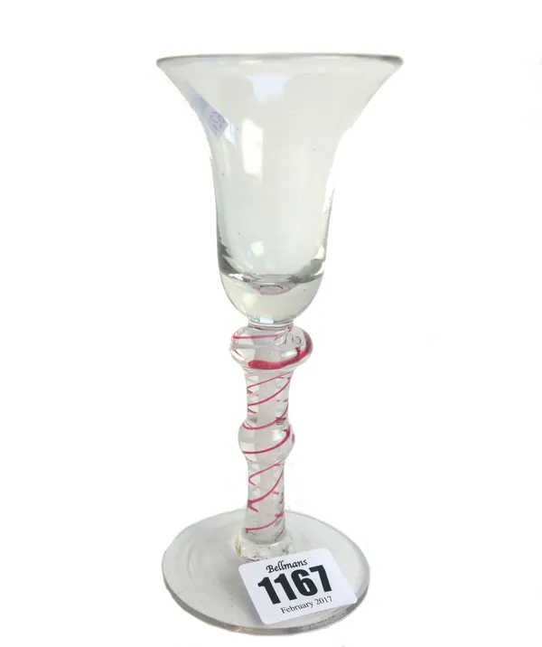 A colour twist wine glass, 19th century, the bell bowl raised on a knopped red and white opaque twist stem and plain foot, 15.5cm.high.