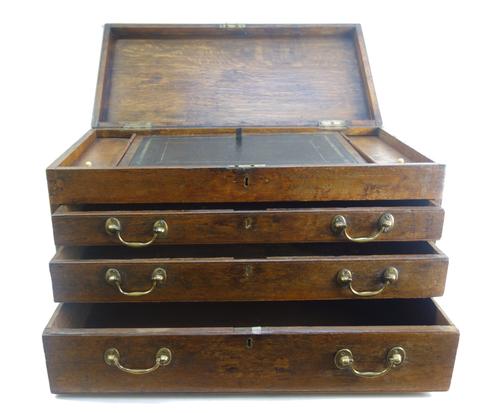 A George III oak travelling desk, the lift top enclosing a fitted interior, 61cm wide x 36cm high.