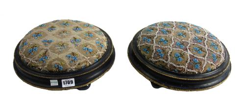 A pair of Victorian ebonised circular footstools, with bead work decoration, 30cm wide (2).
