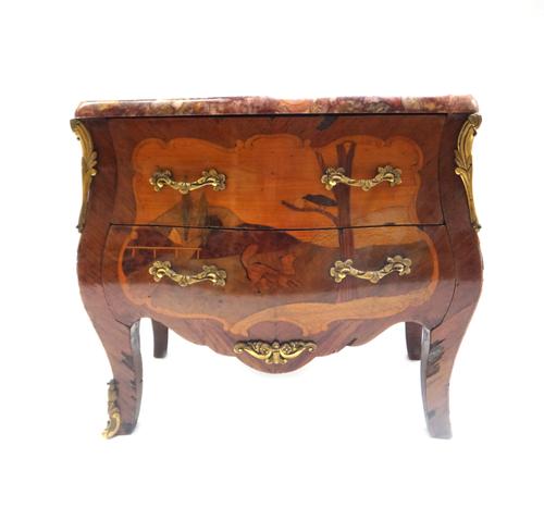 A Louis XV style diminutive marble top gilt metal mounted marquetry inlaid bombe two drawer commode, 31cm wide x 26cm high.  Illustrated