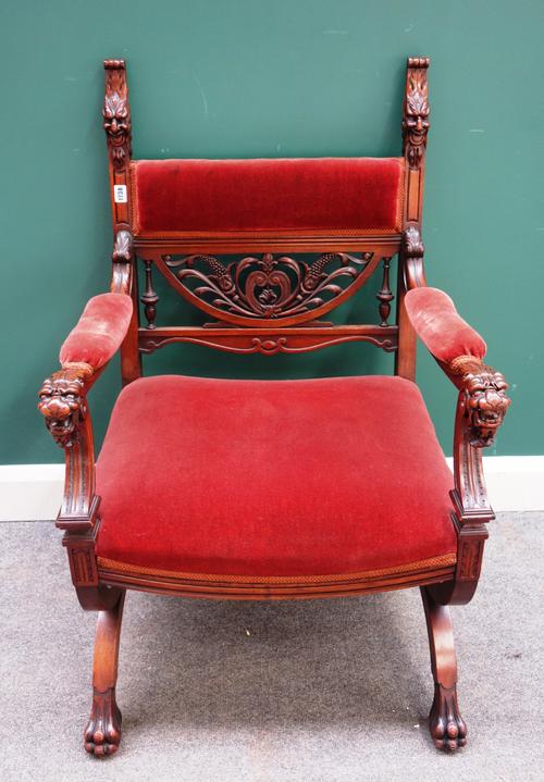 A 19th century continental walnut 'X' framed open armchair, with grotesque and lions mask finials, 67cm wide x 105cm high.
