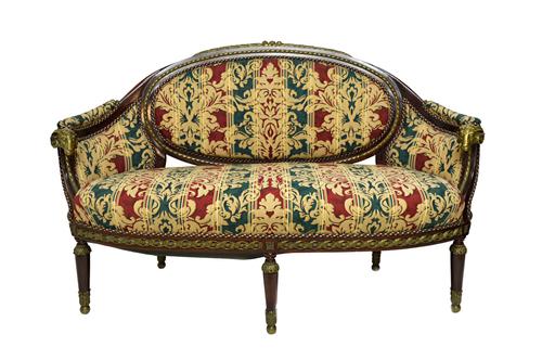 A late 19th century continental gilt metal mounted mahogany tub back sofa, with rams head finials, 165cm wide x 100cm high.  Illustrated