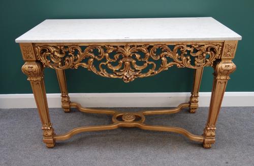 An 18th century style console table, the rectangular white marble top over a carved and pierced giltwood base, on four tapering square supports united
