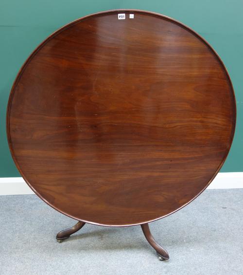 A large George III supper table, with dished circular snap top, on bird cage supports and tripod base, 120cm wide x 69cm high.