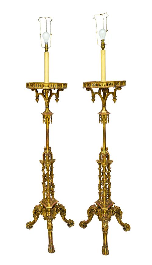 A pair of 18th century style giltwood torcheres, each with galleried top over foliate pierced and carved stems, on tripod base, each 138cm high.