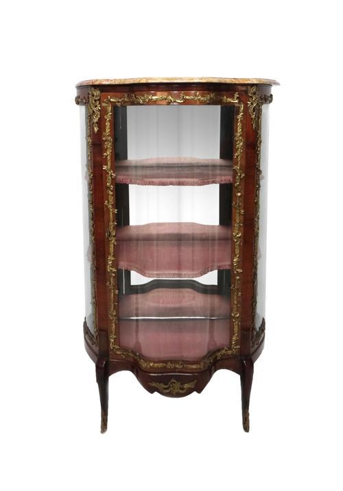 A Louis XV style vitrine, the shaped marble top over a gilt bronze mounted rosewood base, with double serpentine glazed door and shaped glazed side pa