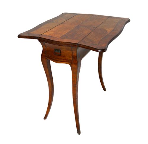 An 18th century French tulip wood lady's games/work table, the butterfly drop flap top over a pair of end frieze drawers and pull out surface, on four