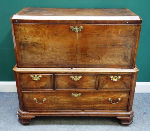 A George III mahogany banded walnut rectangular lift top chest, on associated period four drawer stand, 112cm wide x 106cm high.