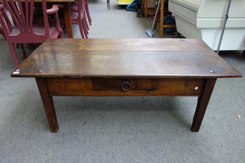 An early 19th century French oak coffee table, reduced from a kitchen table, 140cm x 71cm.