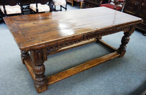 An oak draw leaf table, on carved cup and cover supports, united by perimeter stretcher, with 17th century elements, 91cm wide x 198cm long x 334cm lo