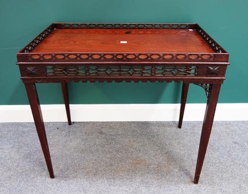 A 19th century mahogany silver table of George III design, the rectangular top with fret pierced gallery and frieze, on tapering square supports, 89cm