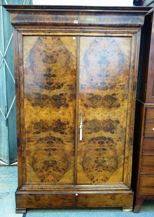 A 19th century continental figured walnut two door wardrobe, with single drawer base, 127cm wide x 197cm high.