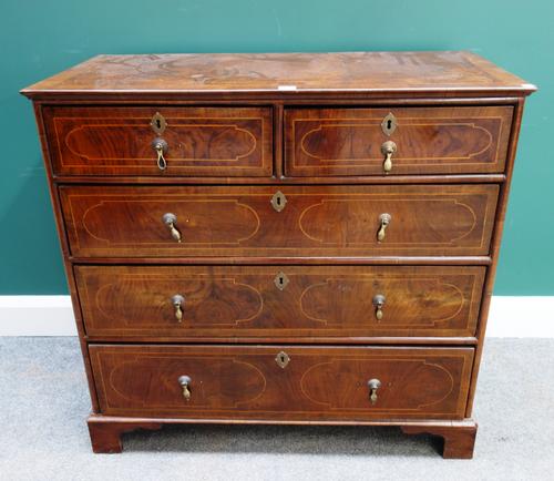 An early 18th century and later walnut chest of two short and three long drawers, on bracket feet, 94cm wide x 90cm high.