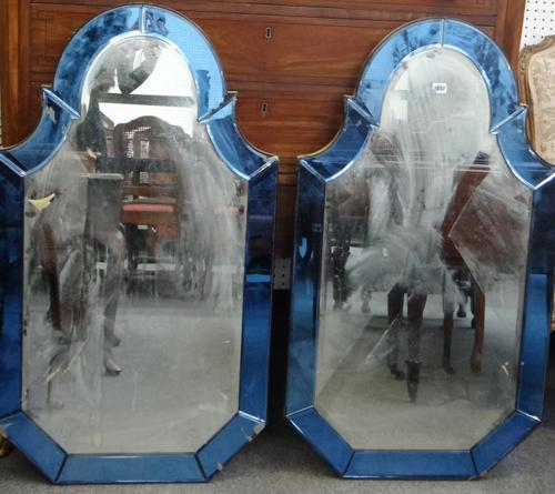 A pair of 20th century blue glass framed arch top mirrors, each 61cm wide x 107cm high (2).