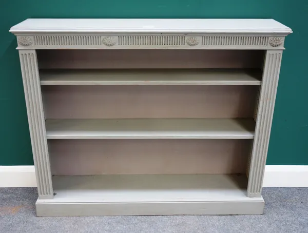 A green painted floor standing open bookcase with channelled decoration, 127cm wide x 104cm high.