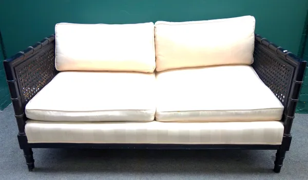 A pair of early 20th century square back two seat sofas, with ebonised faux bamboo supports, 152cm wide x 70cm high, (2).