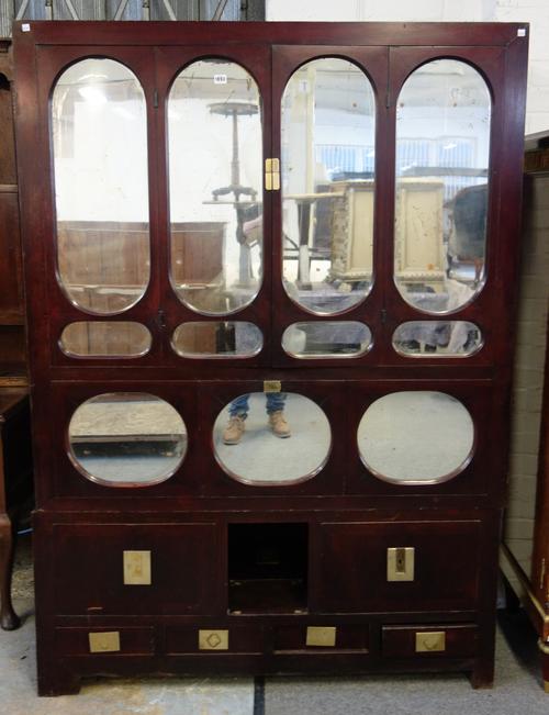 An early 20th century Chinese mirrored side cabinet with an arrangement of cupboards and drawers, 137cm wide x 193cm high.