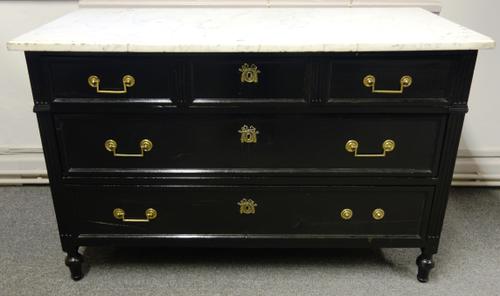 A 19th century French commode, the marble top over an ebonised three drawer base, 134cm wide x 61cm deep.