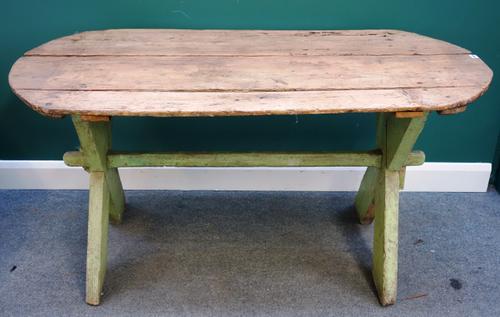 A 19th century pine tavern table, on green painted 'X' frame base, 74cm wide x 157cm long.