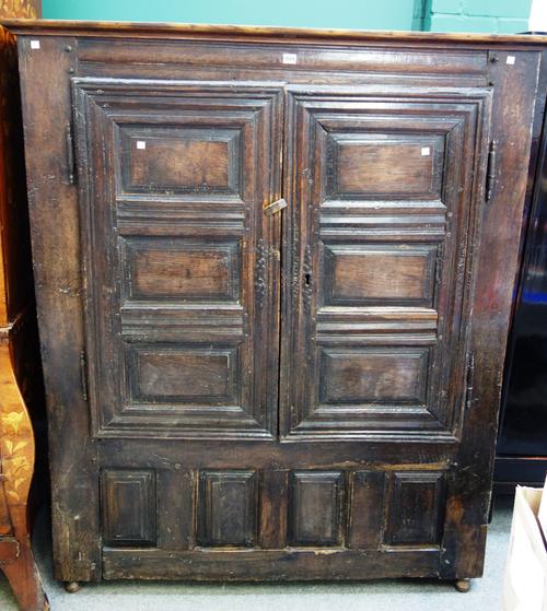 A 17th century and later French oak two door cupboard, 135cm wide x 165cm high.