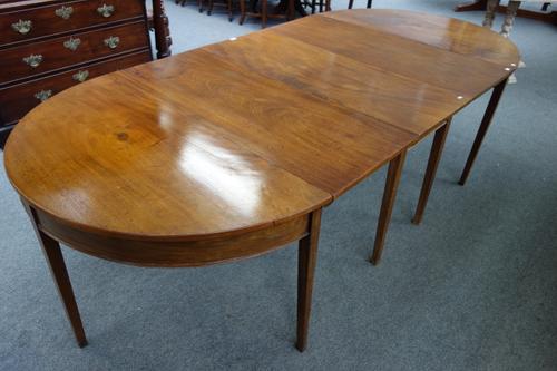 A George III mahogany D-end extending dining table, with drop-flap centre section and one extra leaf, 121cm wide x 259cm long extended.