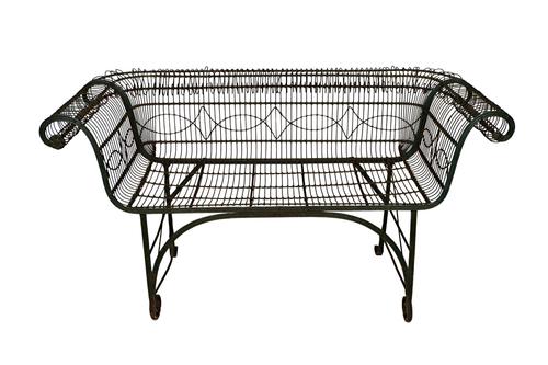 An early 20th century green painted wirework two seat bench, on scroll supports, 140cm wide x 73cm high.  Illustrated