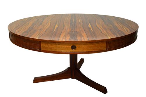 Archie Shine for Heals; a 20th century circular rosewood dining table, with turned column on three supports, 142cm wide x 71cm high (to be sold with C