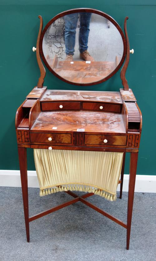 A small Regency mahogany dressing/work table, with swing mirror, on tapering square supports, 55cm wide x 121cm high.