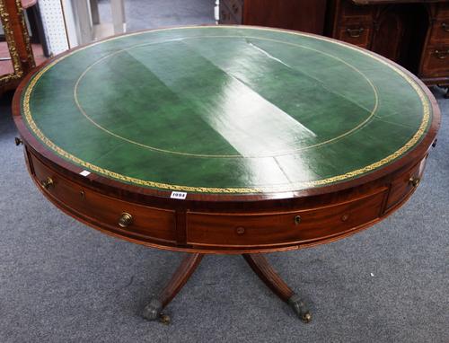 A George III mahogany drum table with leather inset top, on four downswept supports, 132cm wide x 77cm high.
