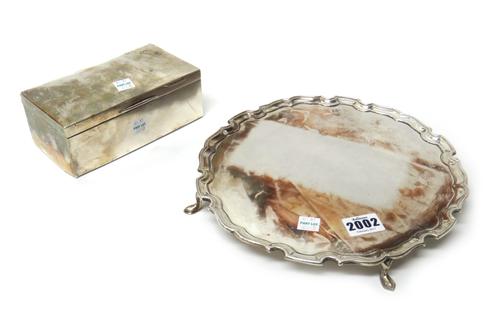 A silver salver, of shaped circular form, with a pie-crust rim, raised on three feet, diameter 25cm, London 1915, weight 606 gms and a silver mounted