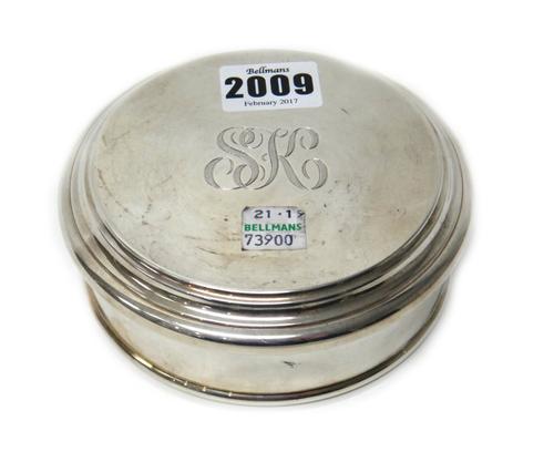A silver circular box and cover, the cover engraved with the initials S K, diameter 12.5cm, retailed by Asprey, weight 313 gms.