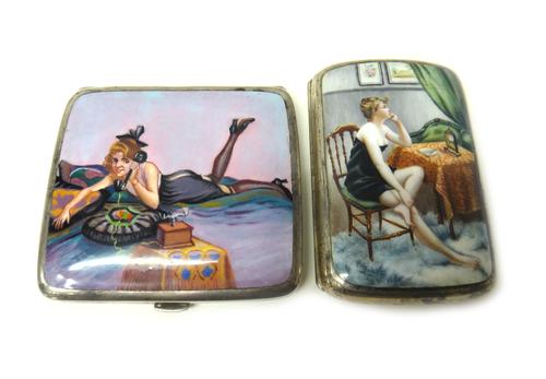 A silver plated and enamelled rectangular cigarette case, decorated with the figure of a seated lady beside a table, with a clock on the table and ano