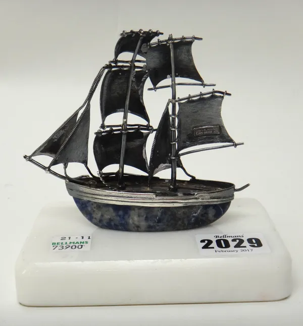 A Greek model of a twin masted sailing boat, detailed Ilias Lalaounis 925 Greece A 21., on a white marble base.