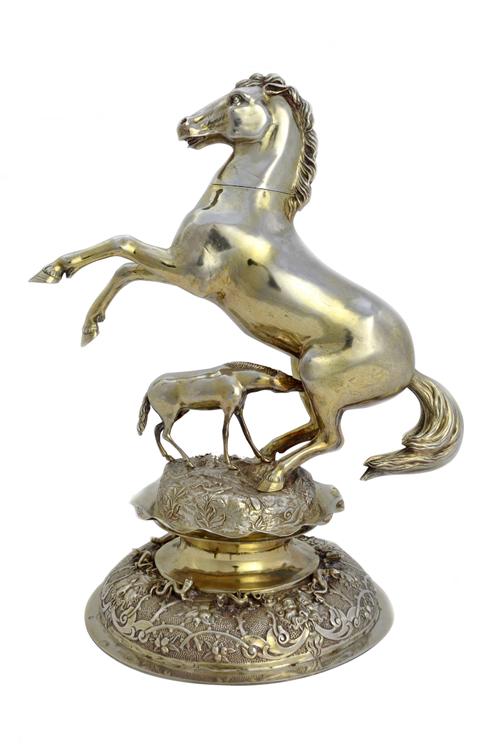A European model of a rearing horse, having a detachable head, with a foal, on a shaped circular base, decorated with masks, lizards and insects, weig