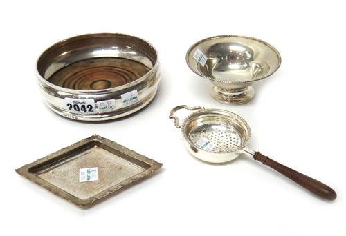 Silver and silver mounted wares, comprising; a bottle coaster, having a turned wooden base, London 1971, a small pedestal dish, a lozenge shaped small