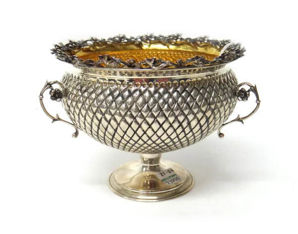 A European three handled flower bowl, the body of simulated pineapple form within a floral and foliate border, raised on a circular foot, diameter 13.