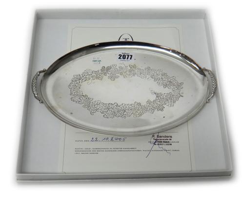 A European twin handled small oval tray, decorated with a wreath of vine to the centre, detailed 925 Koch & Bergfeld, weight 494 gms, length 30.5cm.