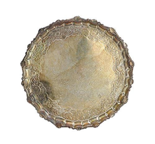 A mid-18th century Scottish silver salver, of shaped circular form, with a pie-crust rim, in the Chippendale style, raised on three pad feet, later de