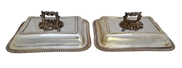 A pair of silver shaped rectangular lidded entree dishes, each decorated with gadrooned rims and with detachable handles, one handle Sheffield 1903, o