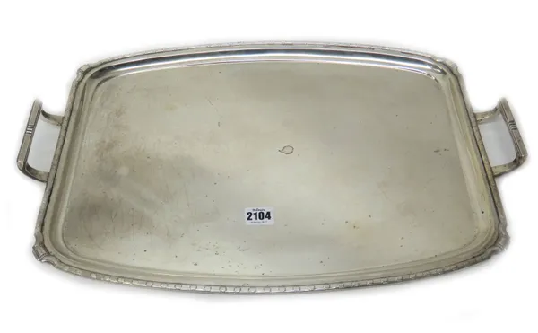 A silver twin handled shaped rectangular tray, length 59cm, London 1927, weight 1310 gms.