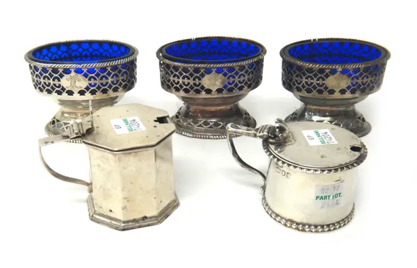 Three George III matching silver salts, each of oval design, with pierced decoration and raised on a pierced oval foot, London 1773, with blue glass l