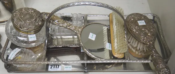 Silver mounted dressing wares, comprising; a circular powder bowl and cover, fitted with a mirror, a clothes brush, a comb, a hand mirror and a hair b