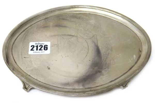 A George III silver oval card tray, engraved with a shield to the centre, within a reeded border, raised on four feet, London 1788, length 21.5cm, wei