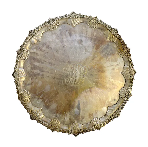 A Victorian silver salver, with a shell and pie-crust rim, in the Chippendale style, raised on three scroll and fluted feet, the centre monogram engra